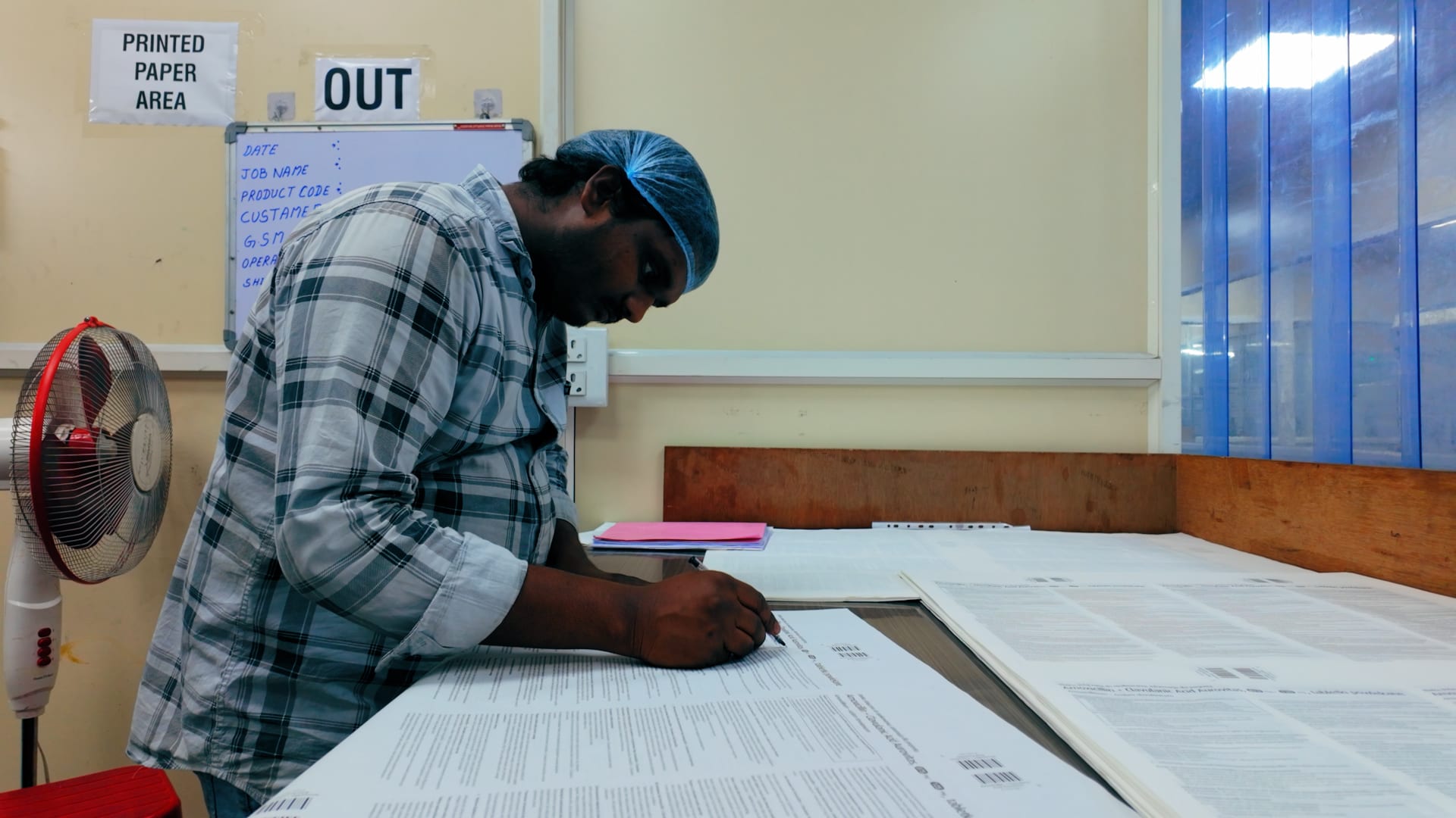 Mudrika staff completing batch documentation at a manufacturing station
