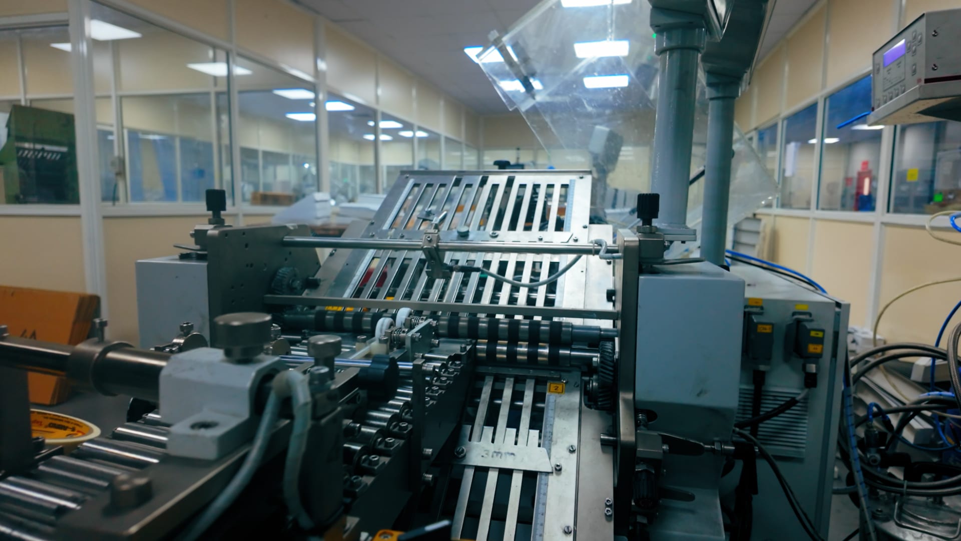 Folding machine rollers processing pharmaceutical literature