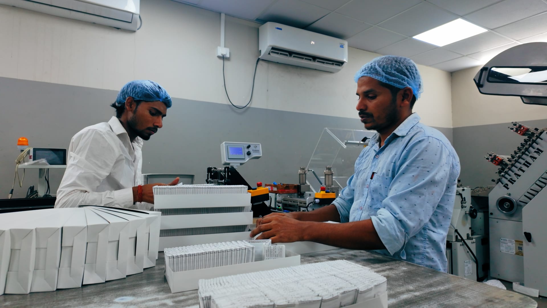 Mudrika staff packing finished pharmaceutical literature for dispatch